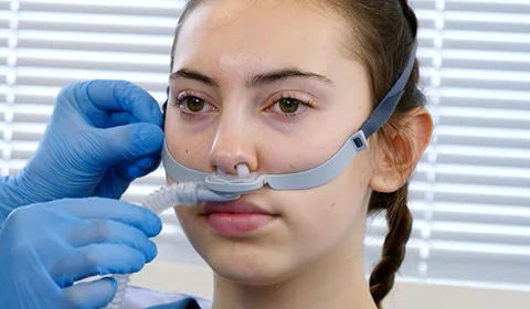 Girl wearing nasal cannula